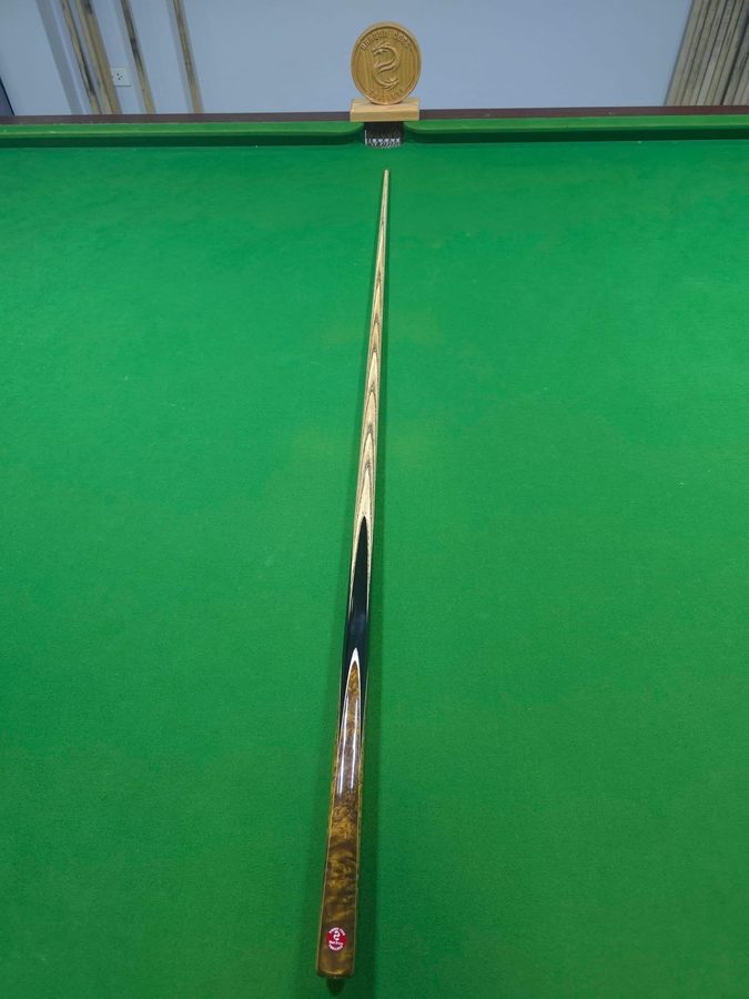 A Dragon Cues Thailand cue commission on a snooker table