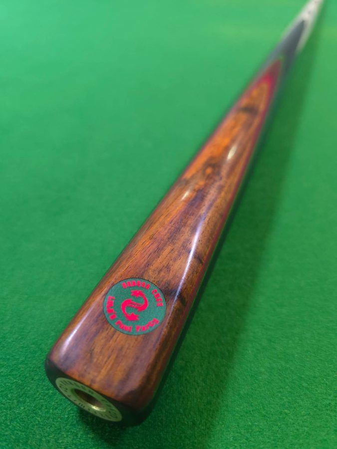 Detail of a Dragon Cues Thailand cue butt and medallion